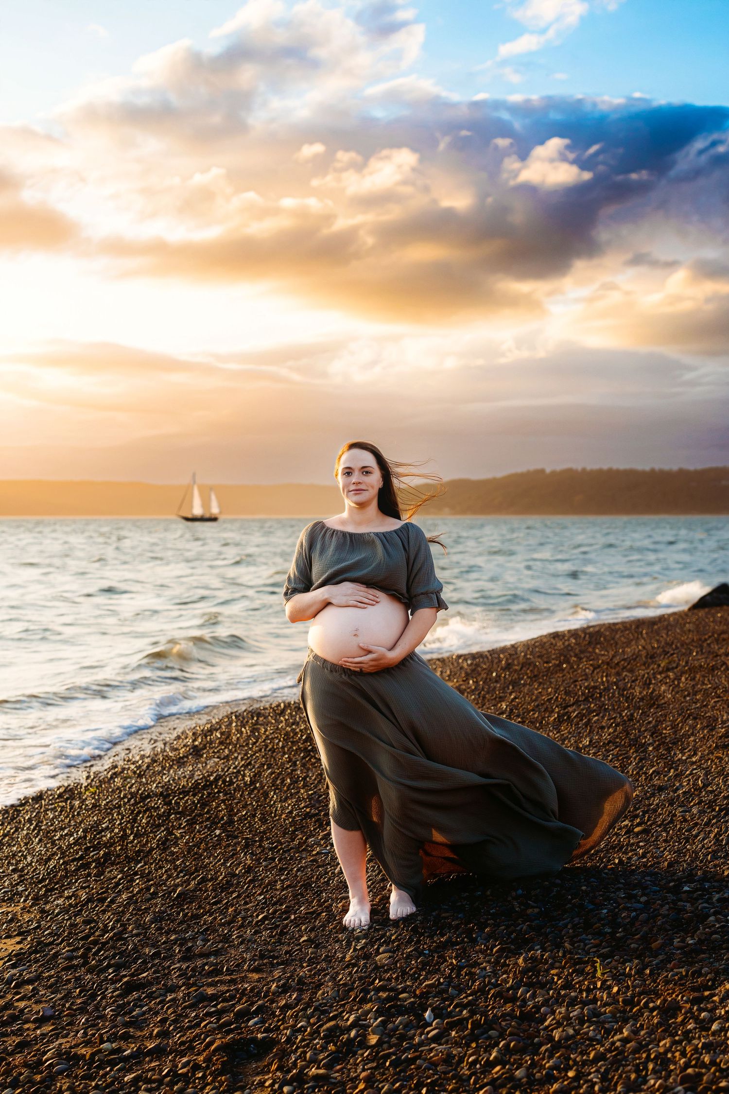 beach maternity session at beach with sail boats