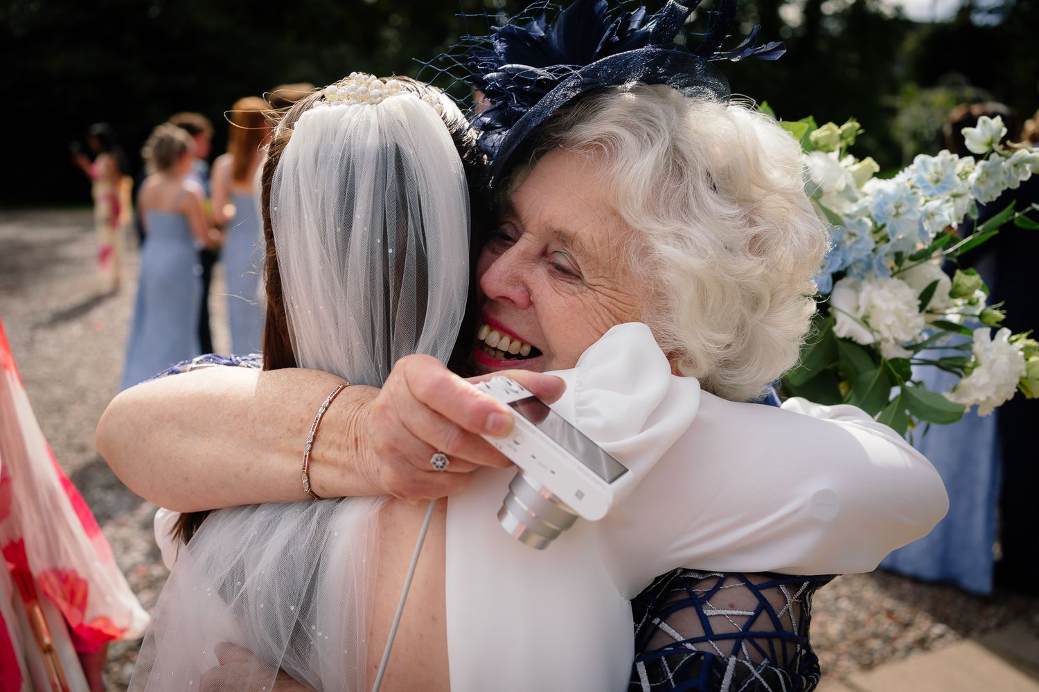 Emotional wedding moment captured as two people share a heartfelt embrace outdoors.