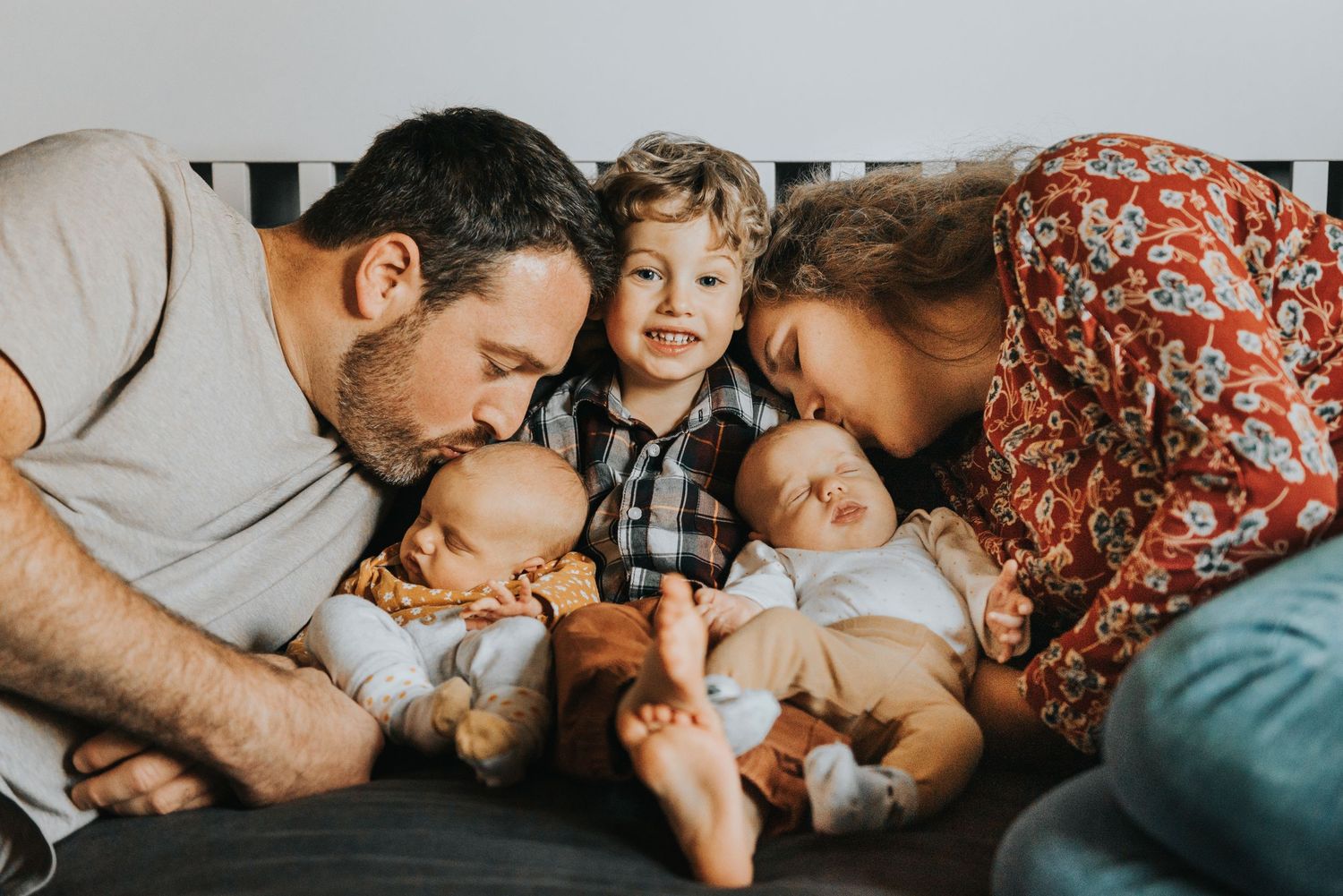 A heartwarming sequence of candid family moments shows affectionate interactions while relaxing together on a couch.