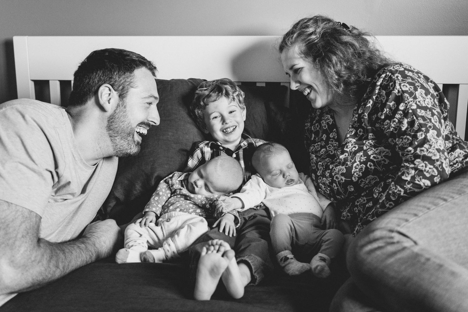 A series of black and white photographs showing tender moments between people in loving embraces.