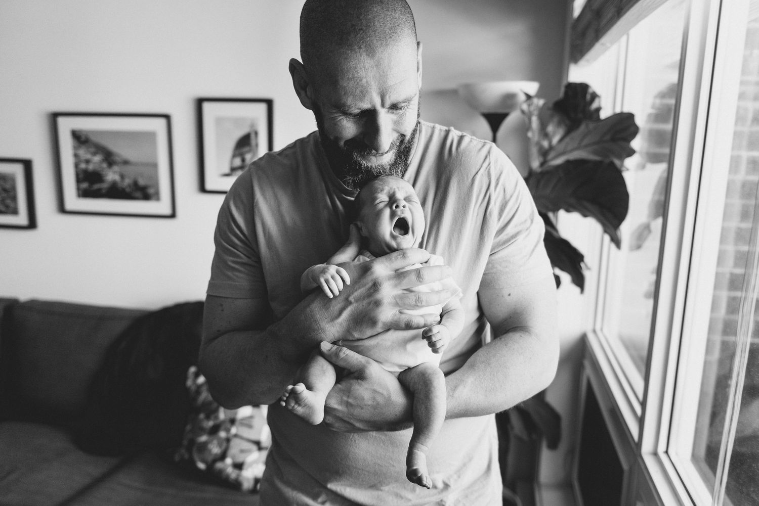 A series of black and white photos showing someone holding and feeding a small baby in various tender moments.