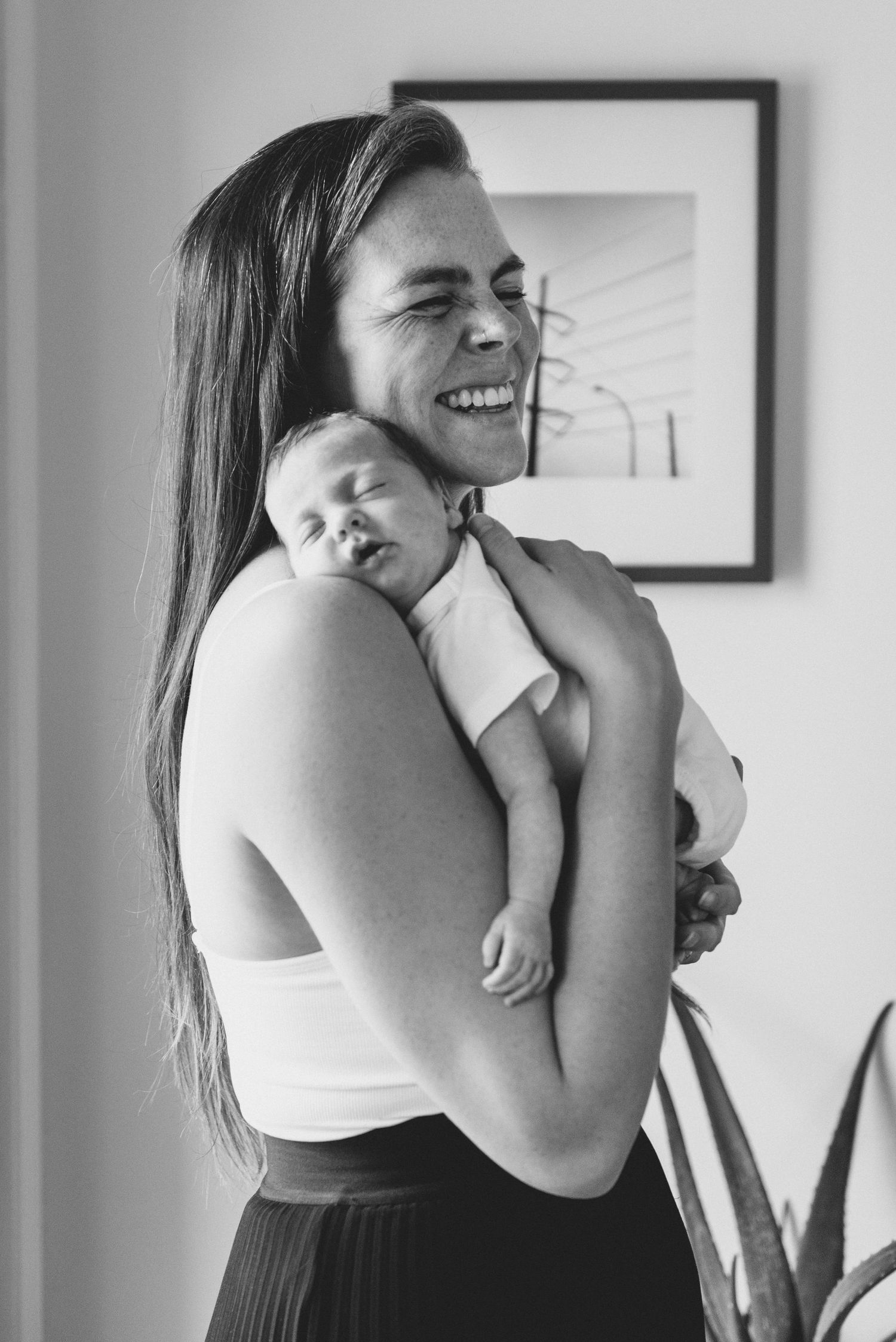 A series of black and white photos showing tender moments between a parent and child embracing.