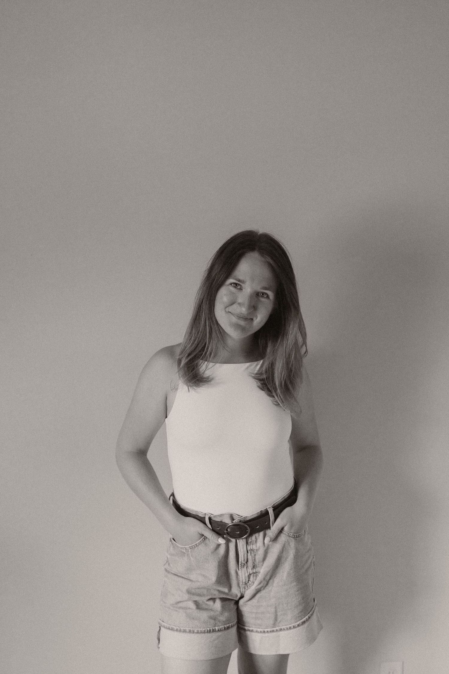 Minimalist portrait series against a grey background showing casual summer style.