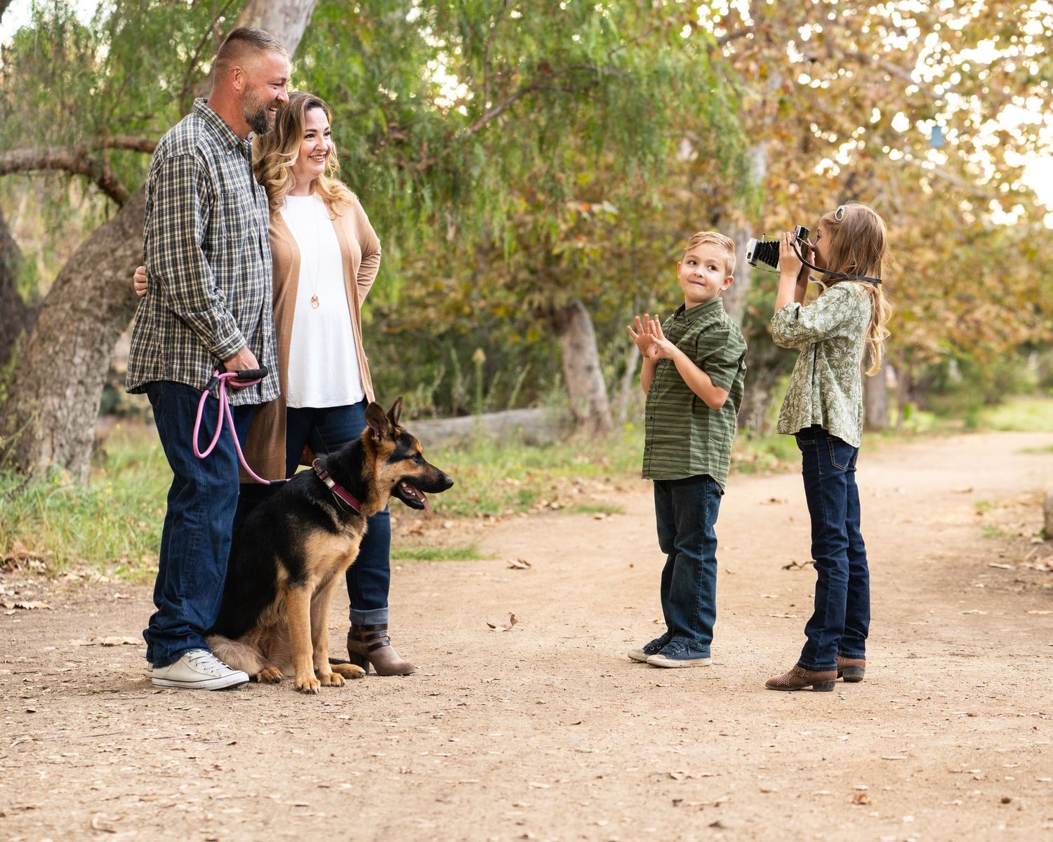 young-family-posing-for-a-polaroid-in-a-park