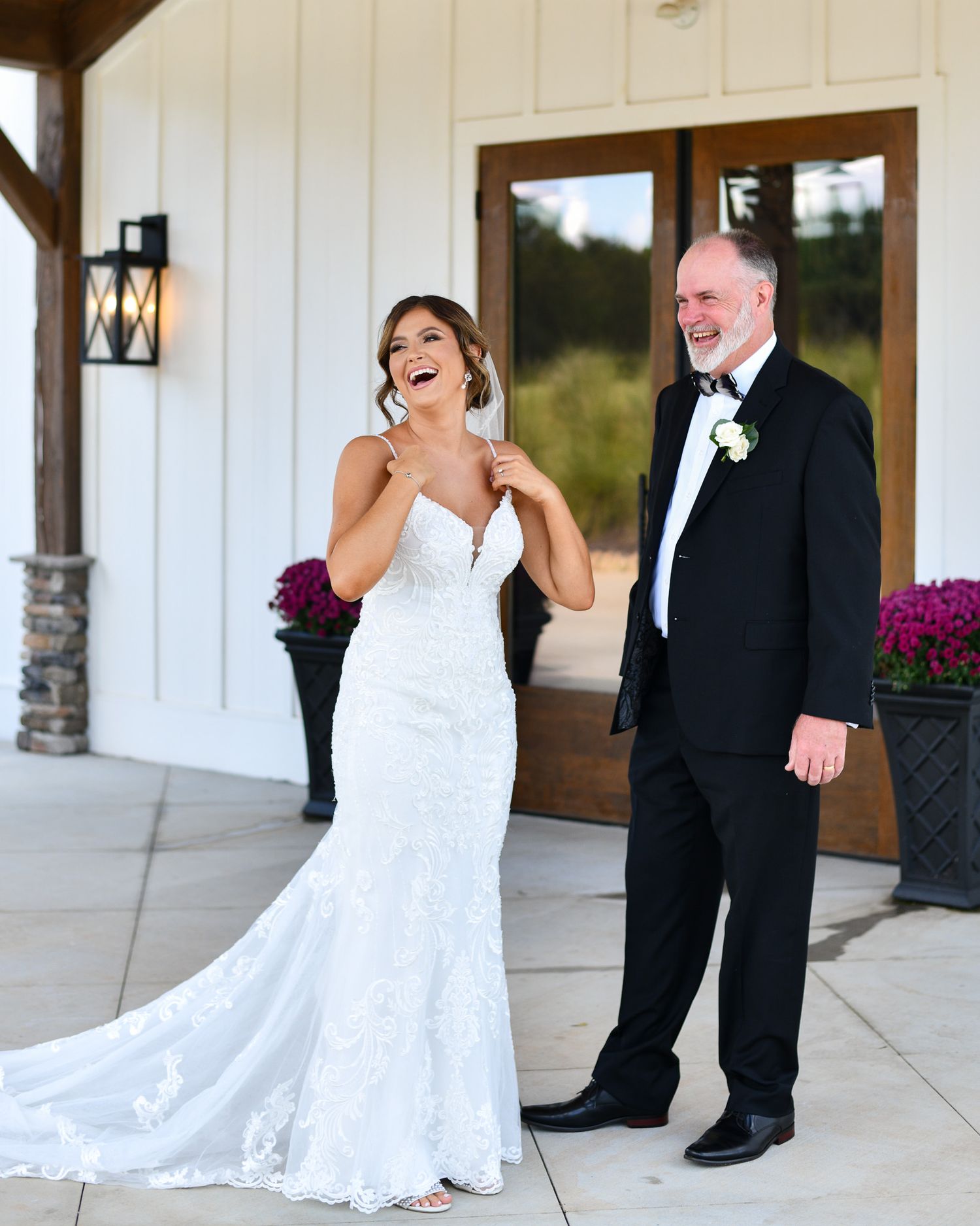 Emotional first look reaction on white building porch during wedding day.