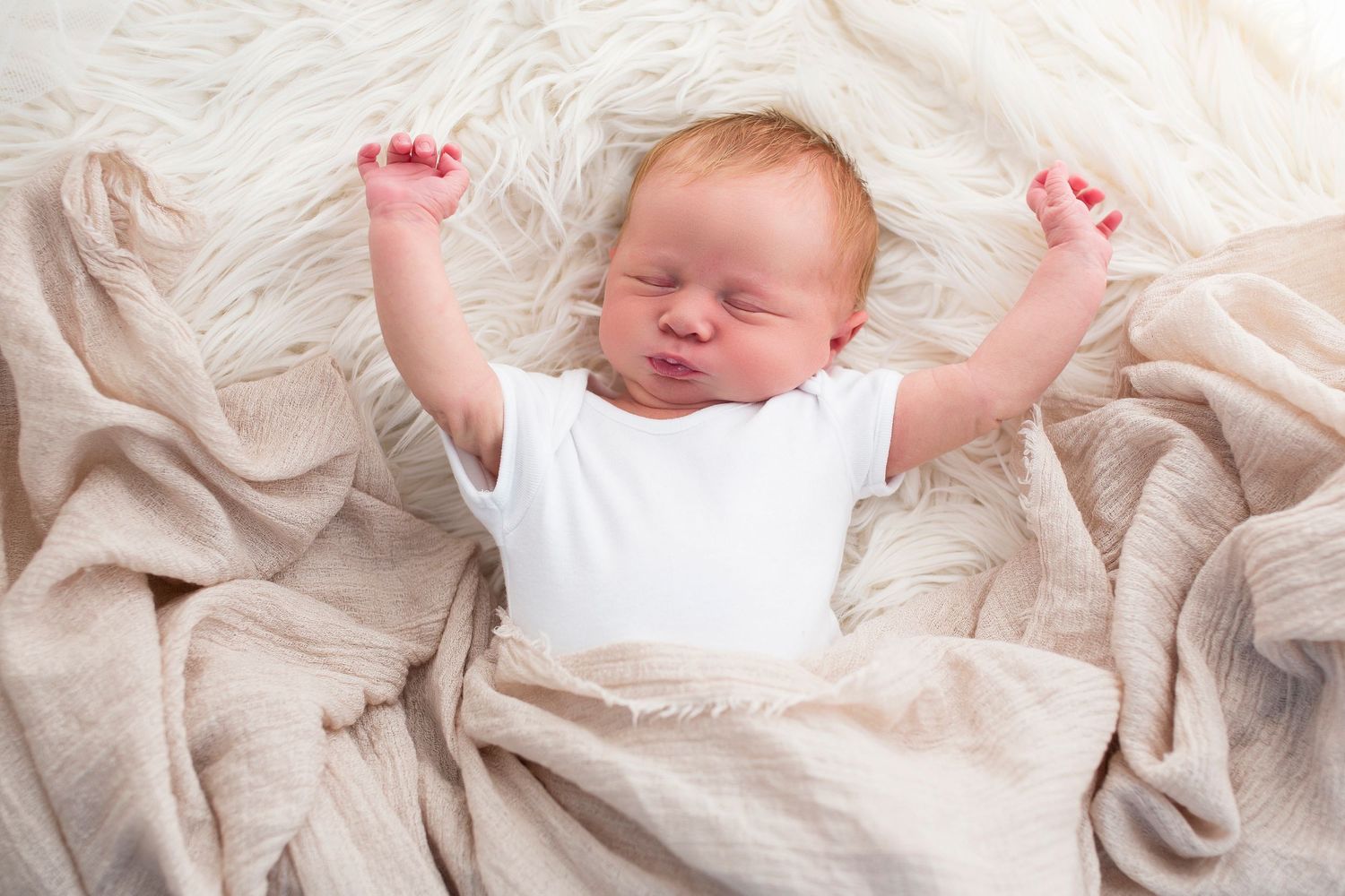 Newborn baby stretching, photographed at Little Wonderland Photography, Widnes, Cheshire