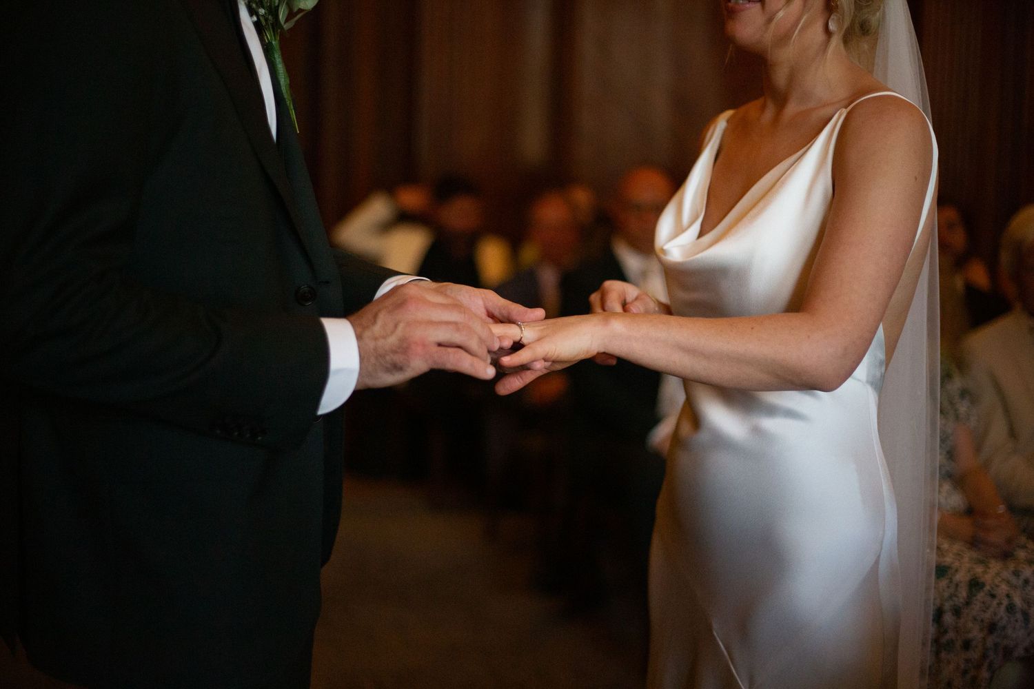 groom putting ring on bride at Old Marylebone Town Hall in London by Dominique Lauren Photography