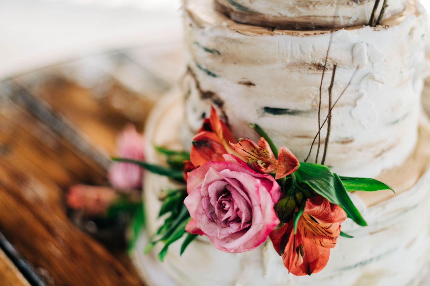 rustic birch tree wedding cake with pink and red flowers