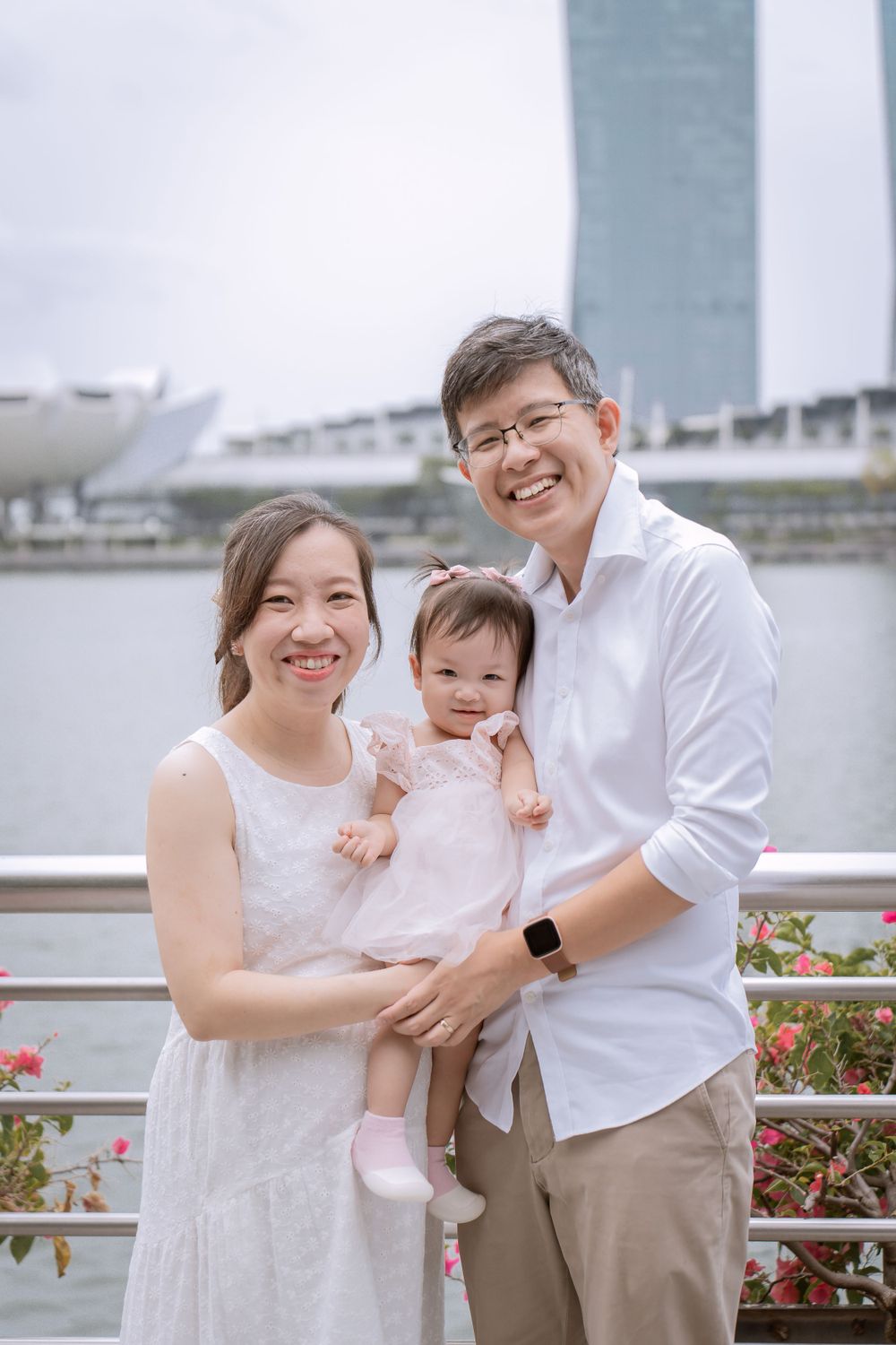 Family portrait taken at Marina Bay with iconic Singapore skyline in background.