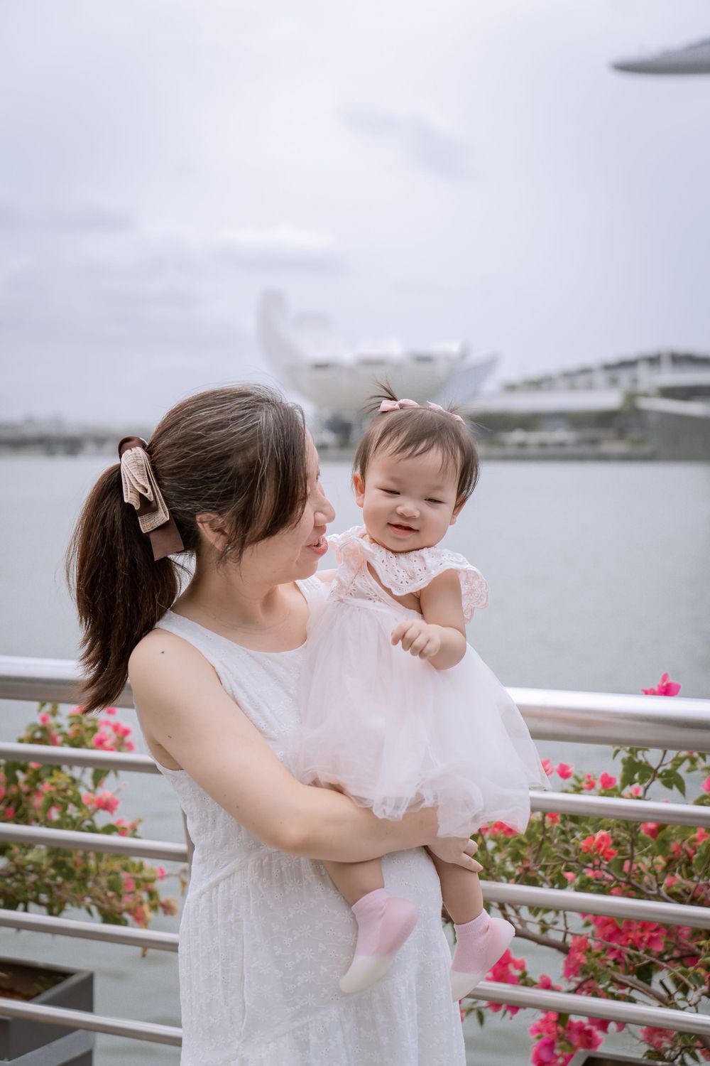 Tender moment between parent and baby with Singapore's Marina Bay in the background.