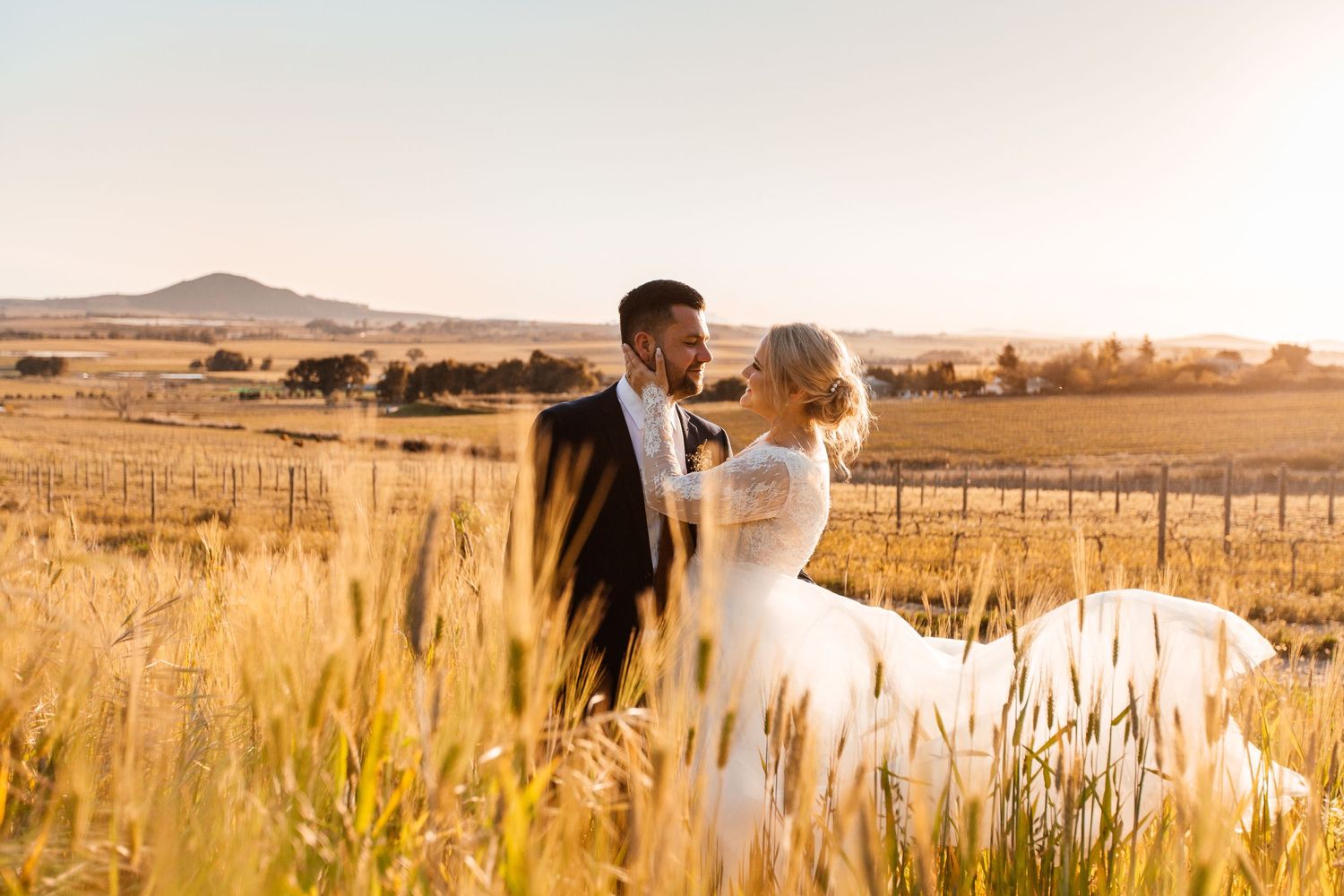 couple in a sunlit field at Diamant Estate in Paarl