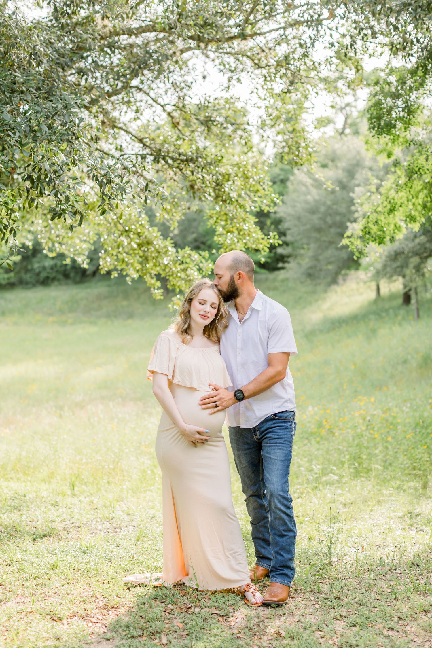 Outdoor maternity photography in a peaceful garden setting with soft lighting.