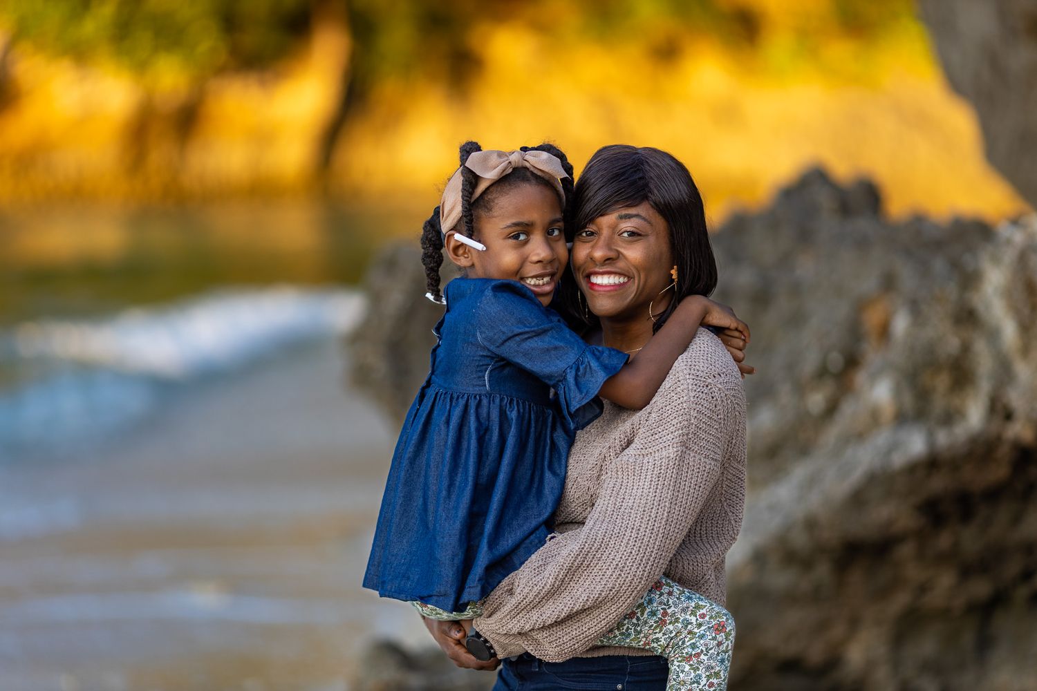 A joyful outdoor portrait at golden hour by the ocean.
