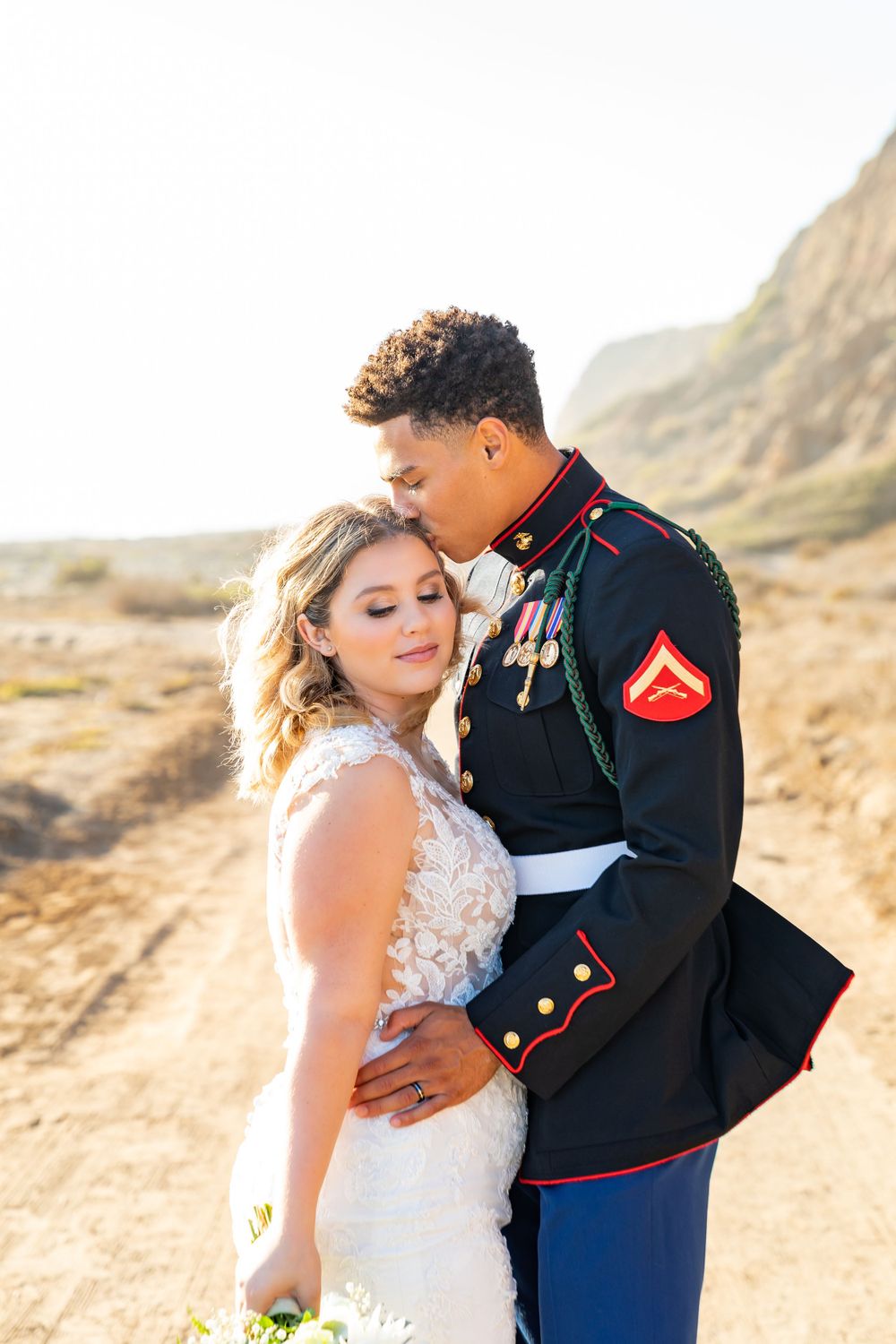 An intimate portrait of a wedding couple against a rugged desert landscape.