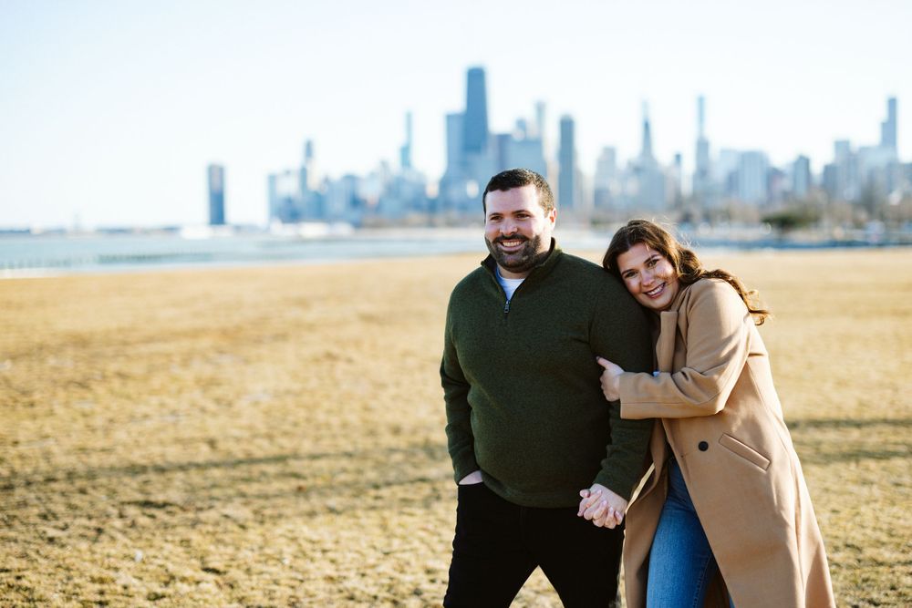 Lovebirds share a tender moment along Lakefront Trail at Fullerton Lake during engagement session