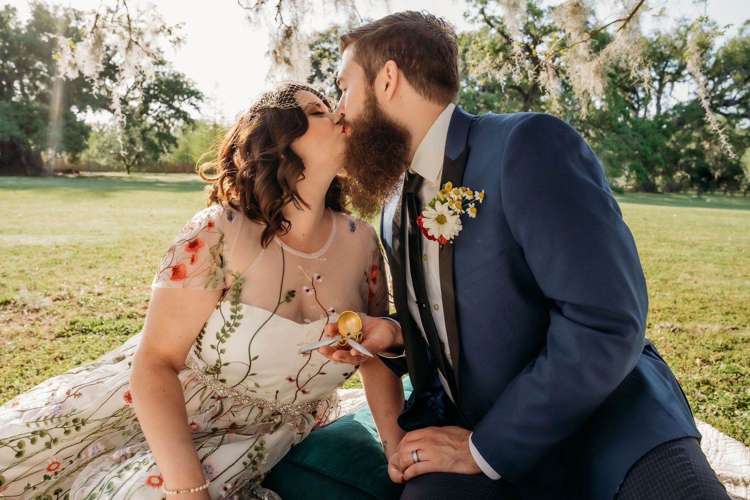 Bride and groom share a kiss in Audubon park.