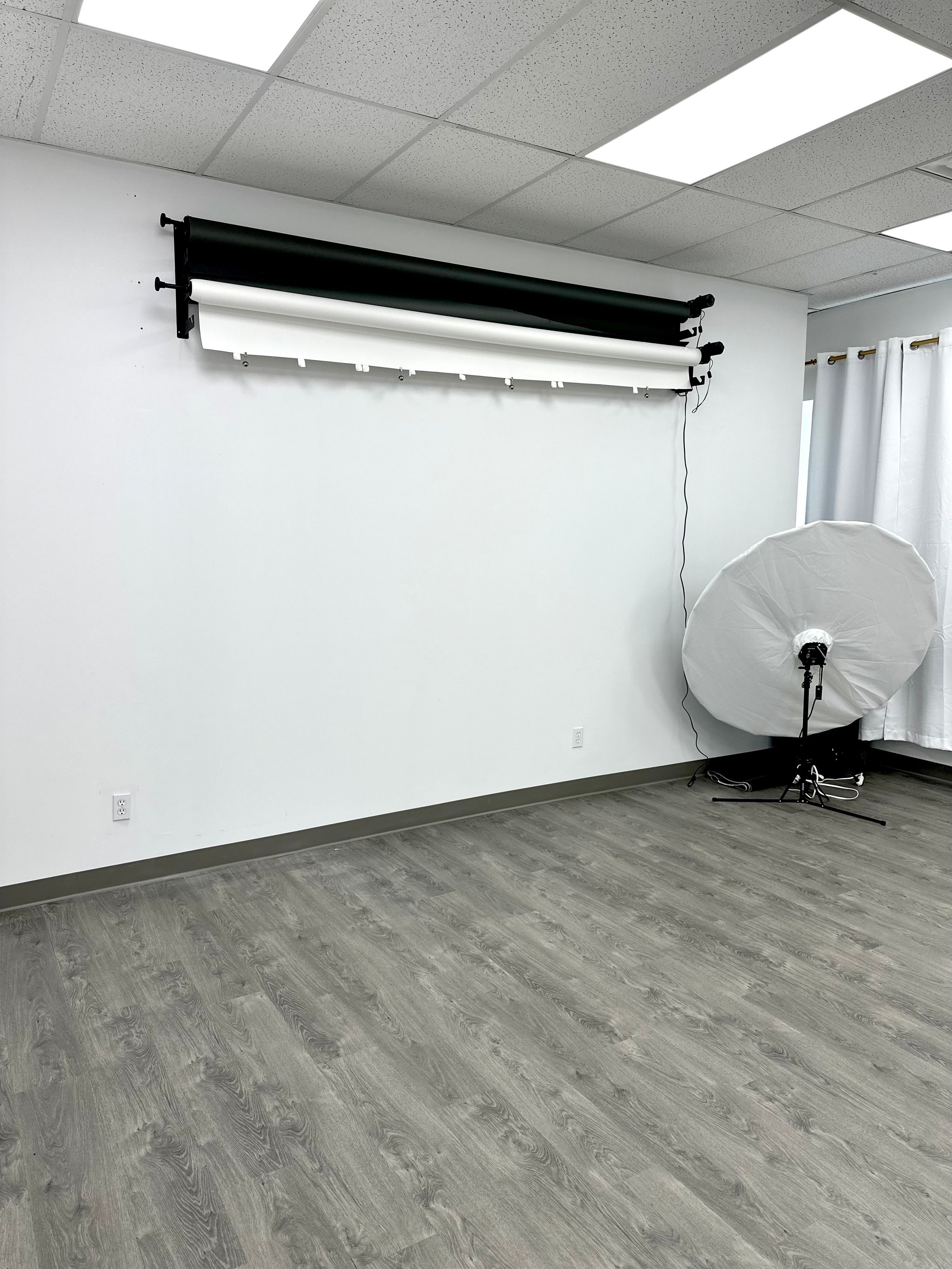 Photography studio setup with backdrop and lighting equipment.