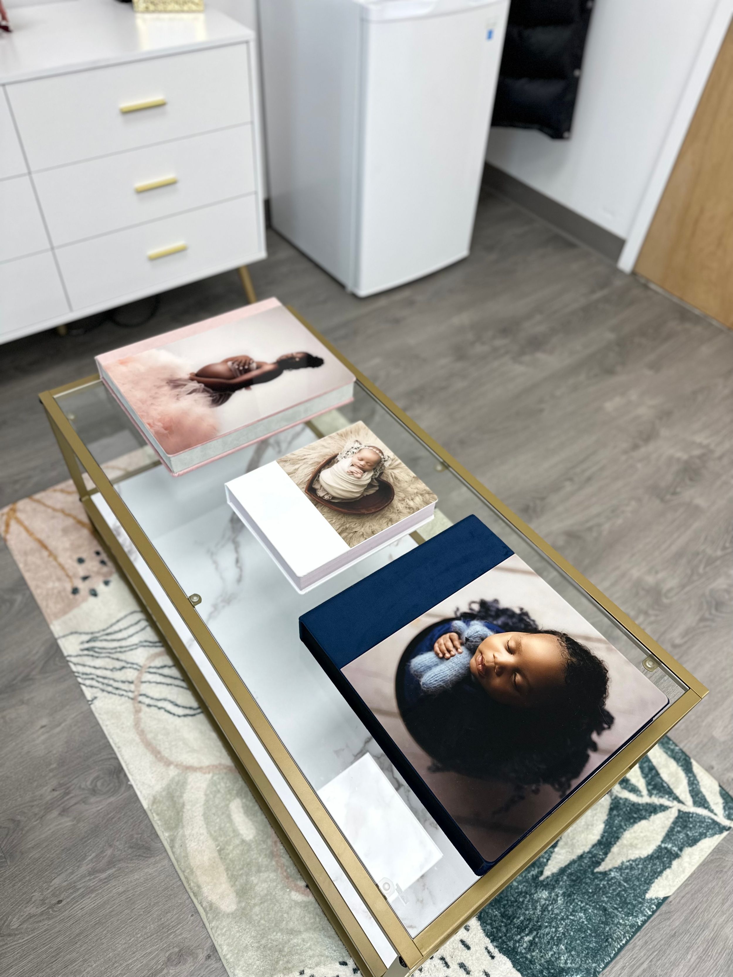 Coffee table displaying professional photo prints in a modern studio setting.