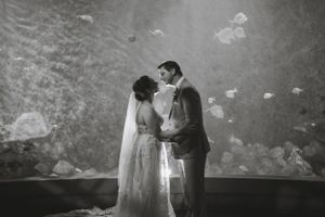 A romantic black and white wedding portrait with a dreamy, ethereal background.