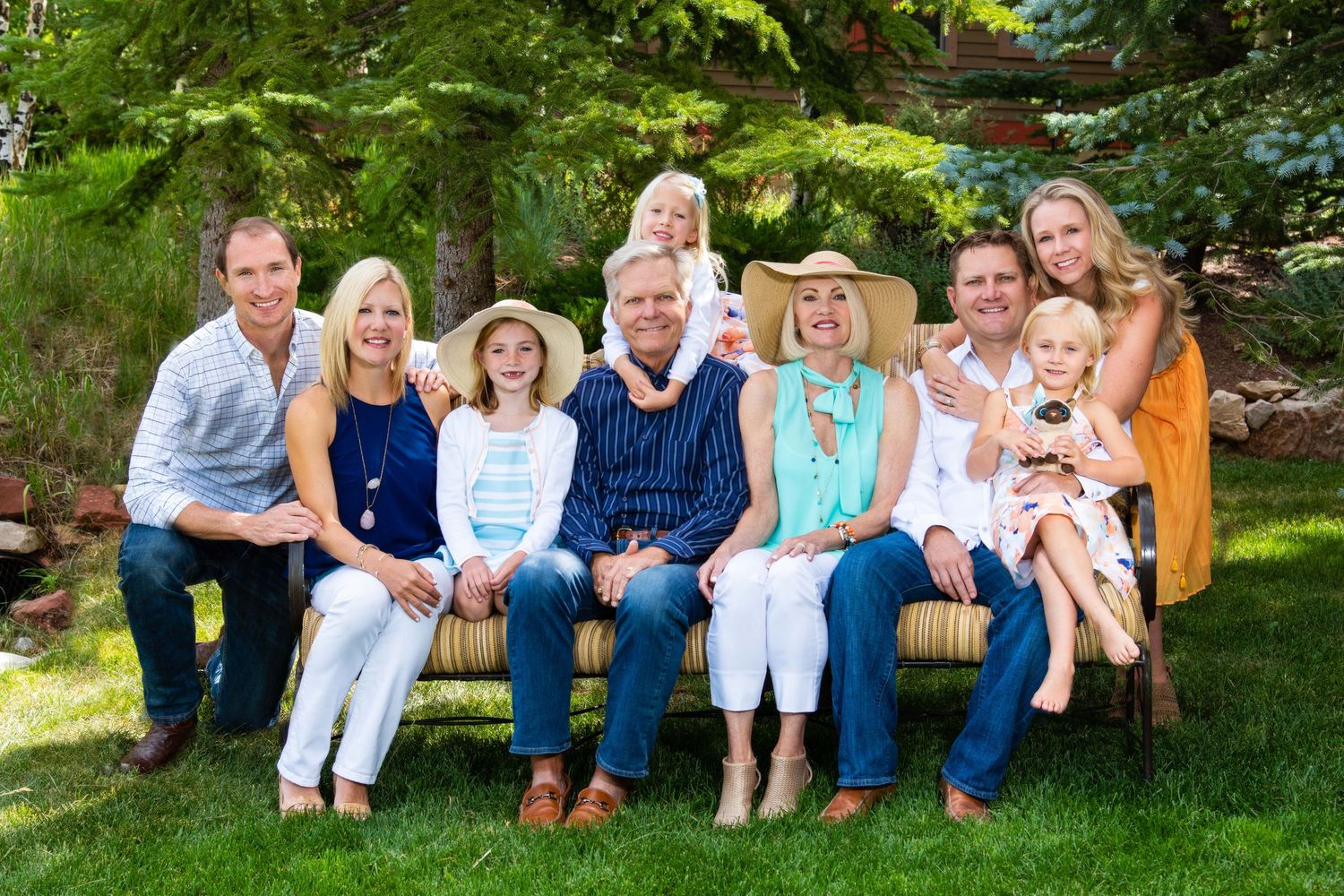 Three generation family outside on a sofa in the summer