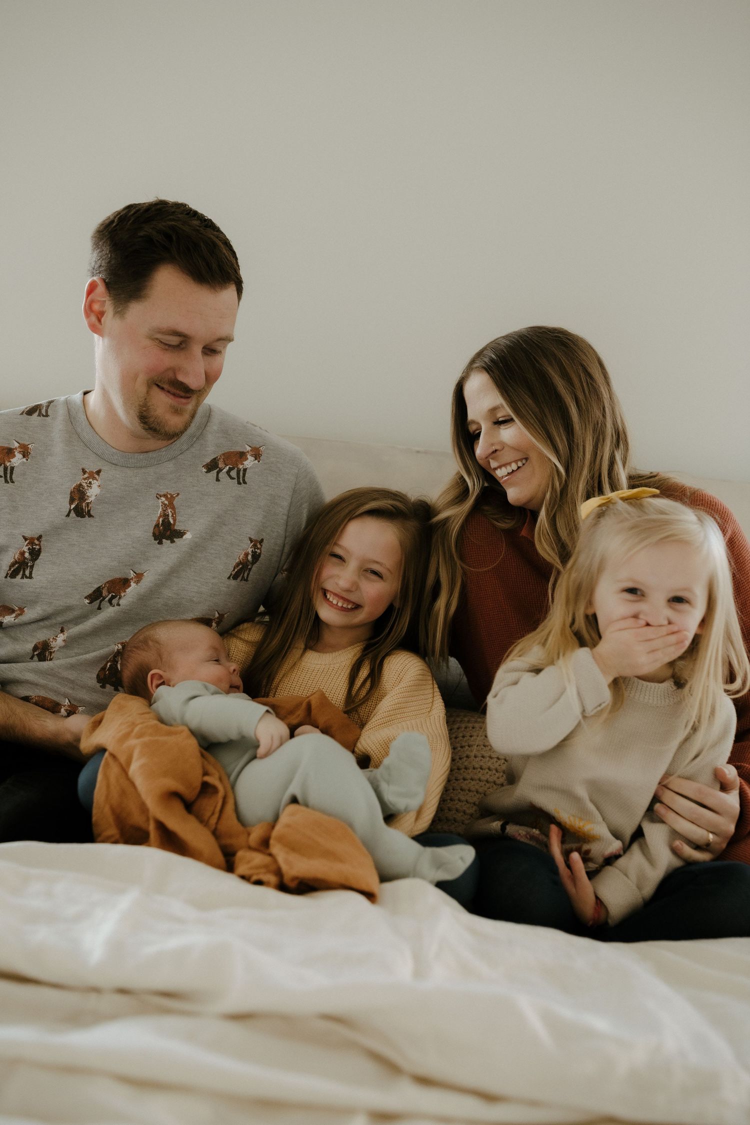 Candid family portrait in Joplin, Missouri captured in natural light by Modern Moods Imagery, showing genuine connection and movement.