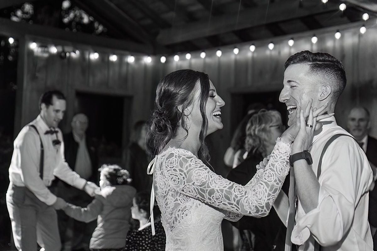 Photography of bride and groom dancing with guests at wedding reception
