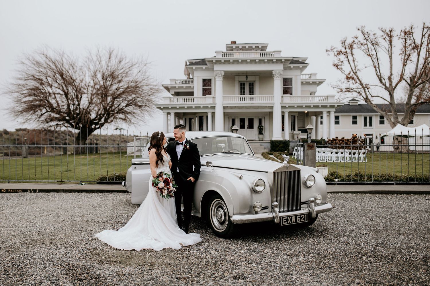 Bride and Groom stand beside vintage Rolls Royce outside of The Moore Mansion in Pasco, WA.
