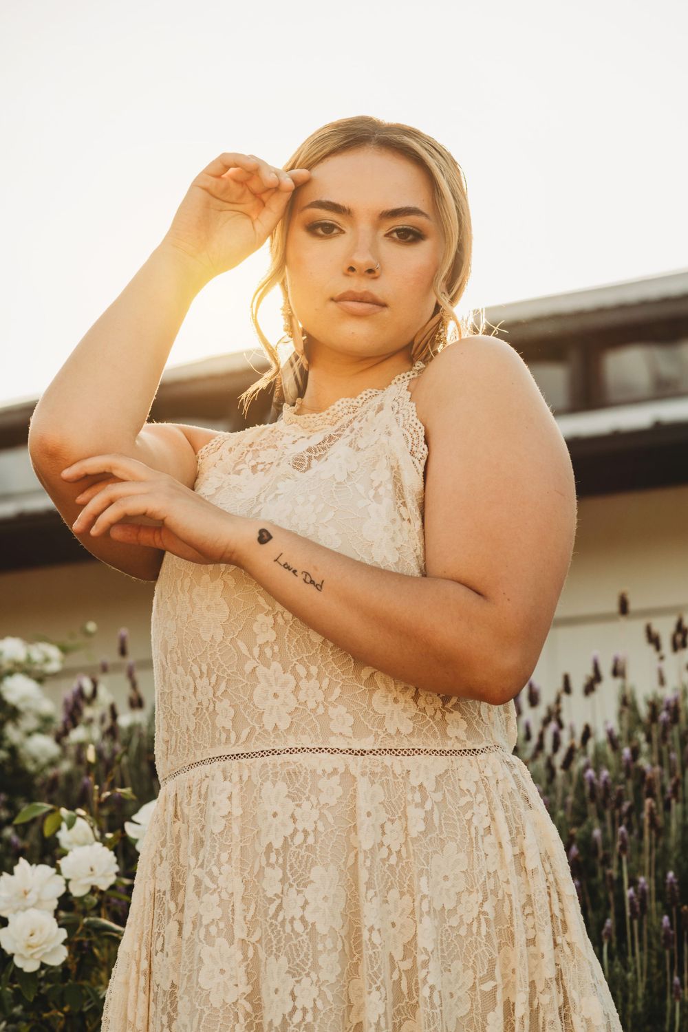 Cream lace dress photographed in garden setting during golden hour.