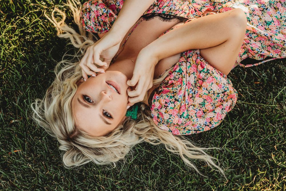 Floral dress fashion shoot on grass with natural lighting.