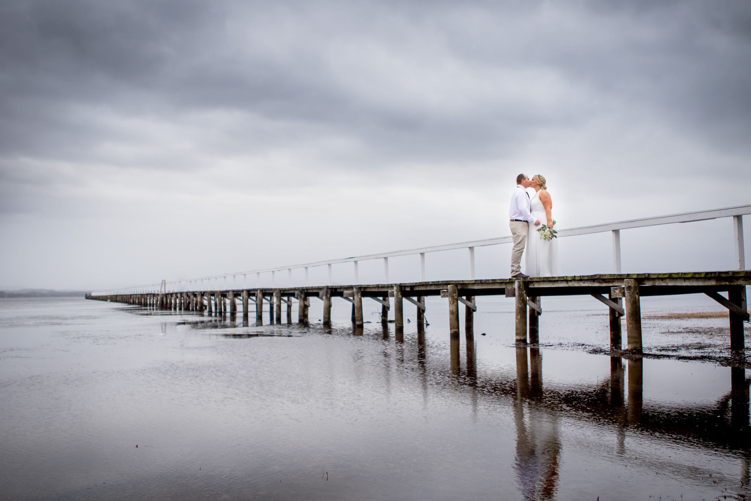 wedding couple on dramatic wharf