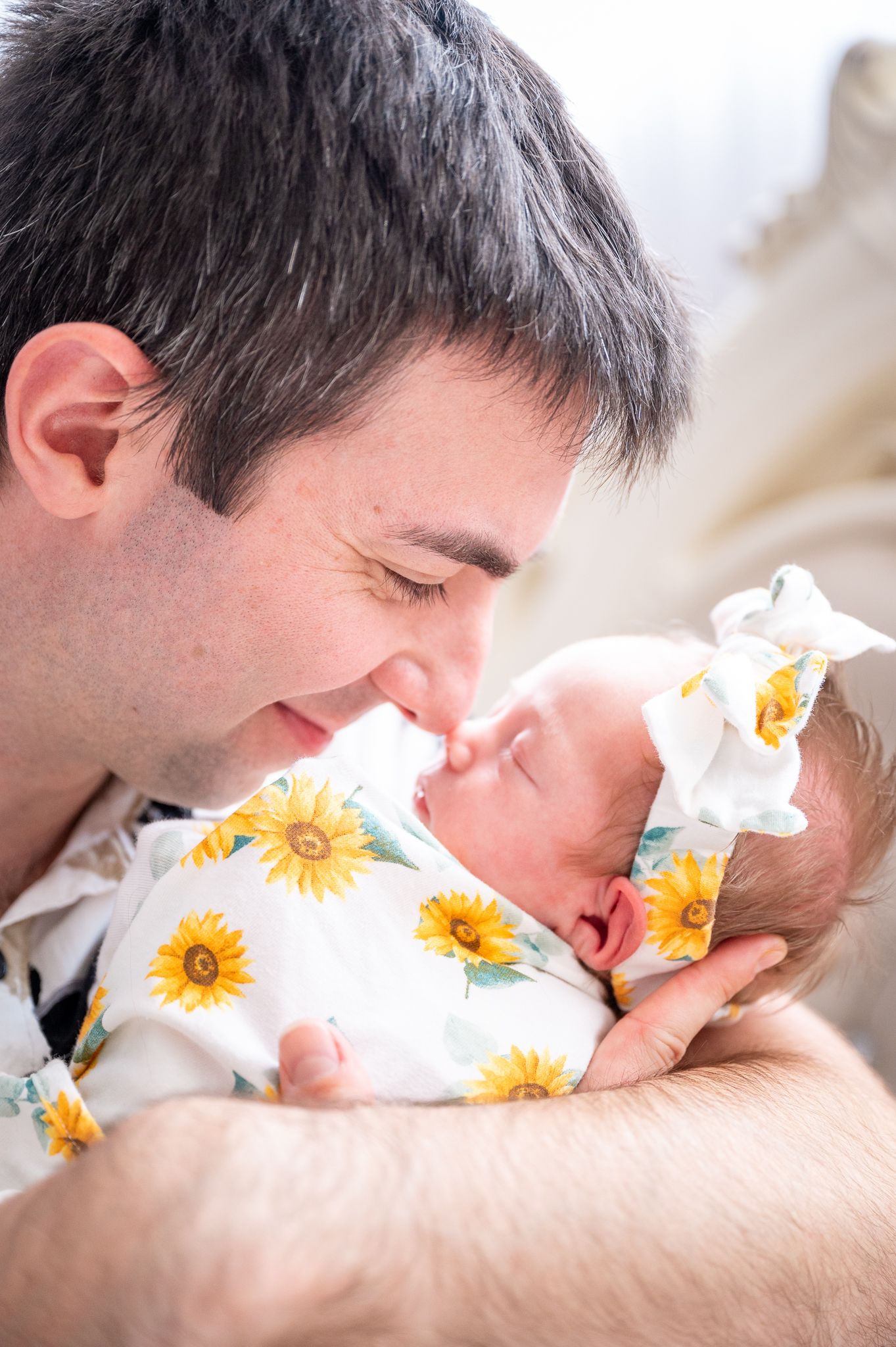 Dad nuzzling his daughter