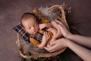 sleeping newborn baby with parent hands in Wolverhampton