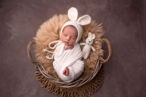 softly posed newborn baby with bunny bonnet Wolverhampton
