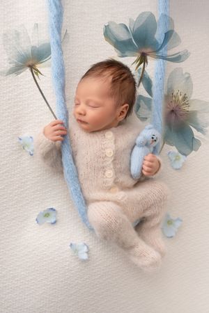 baby boy in swing newborn photography