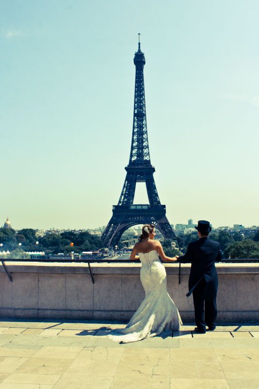 Bride and Groom captured in a beautiful portrait with the Eiffel Tower behind them
