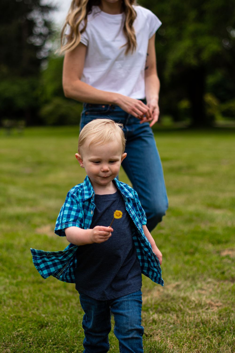 Little boy being chased by mom at a park in Redmond WA having fun.