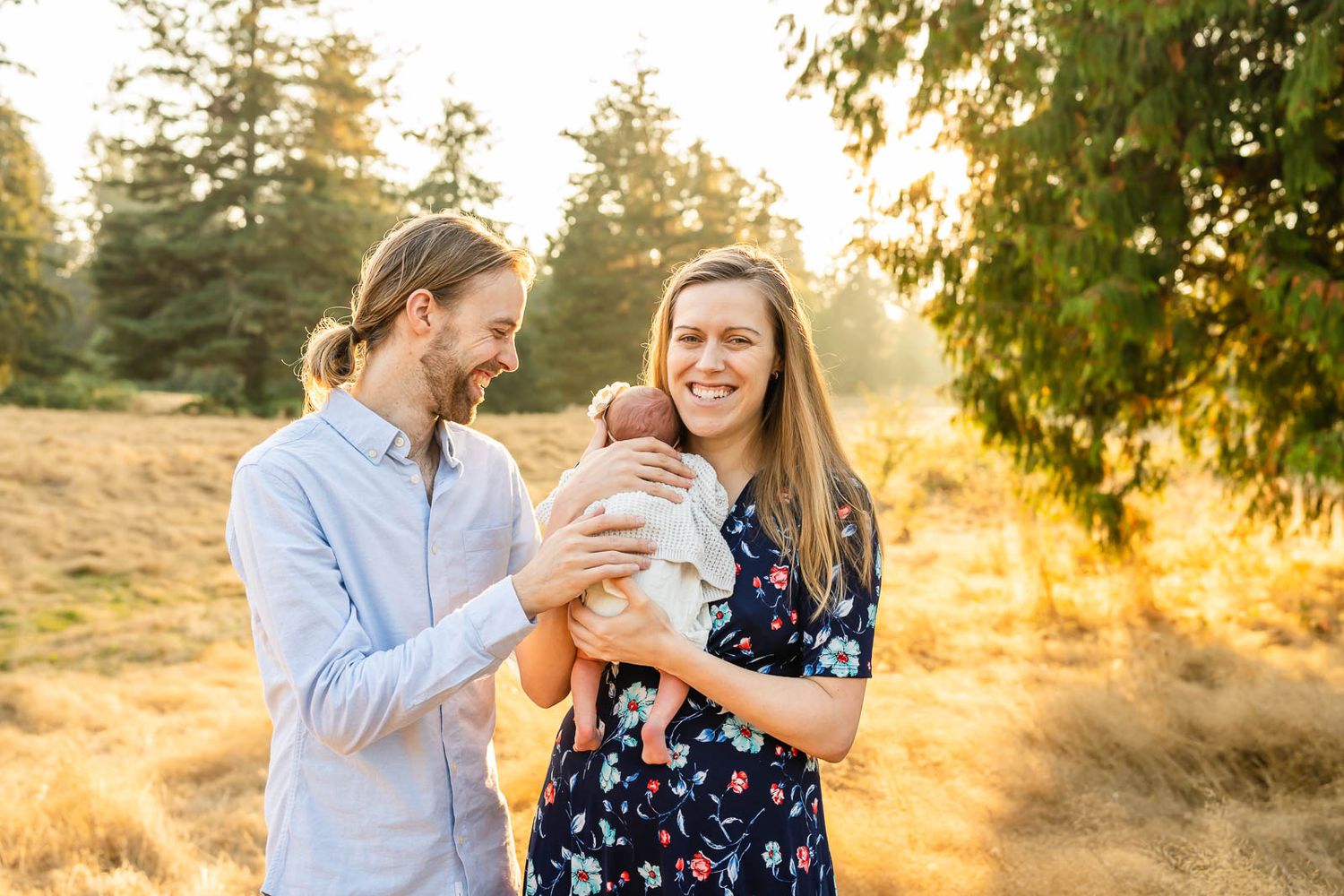 Parents cuddling their newborn at Wellington Hills