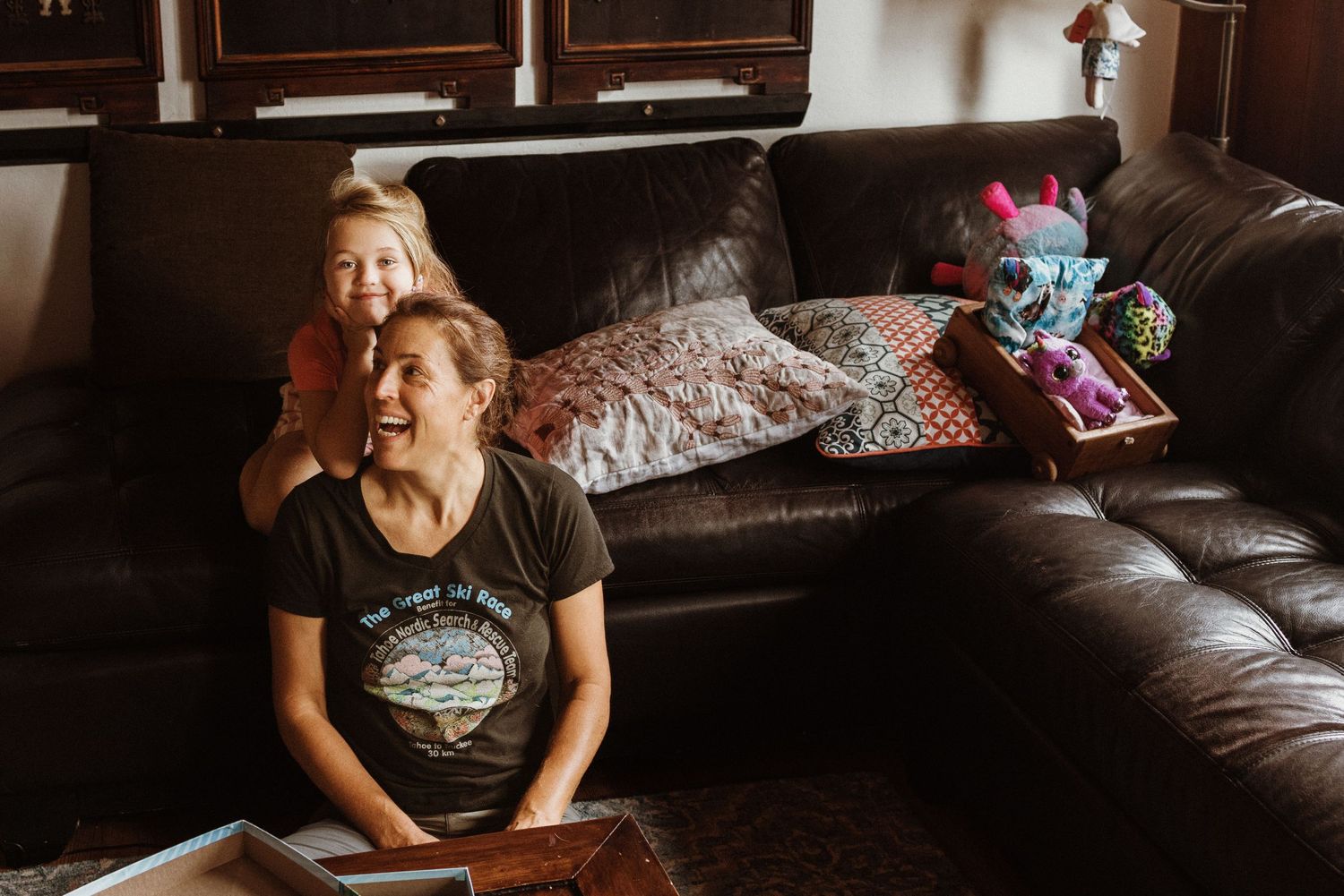 mother and daughter laughing on the floor of the living room