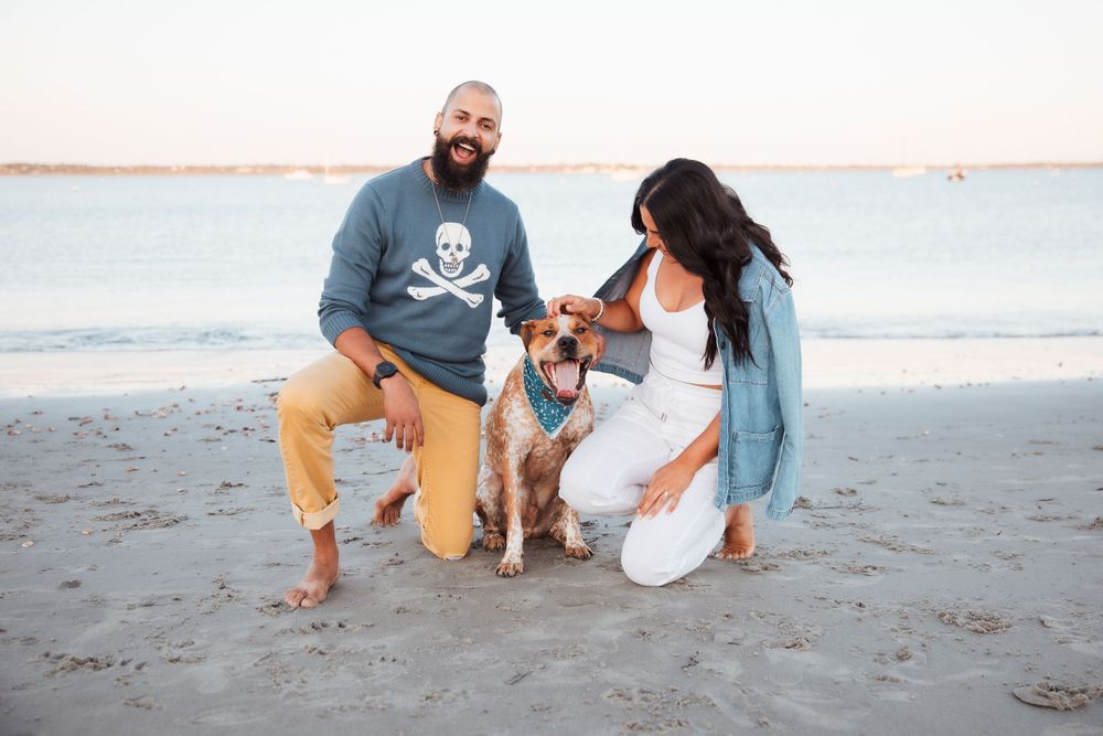 Family and their mixed breed dog playing together on sandy beach at sunset. third beach middletown Rhode Island