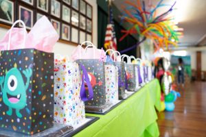 Festive monster party decorations displayed along a hallway with polka dot backgrounds and hanging elements.