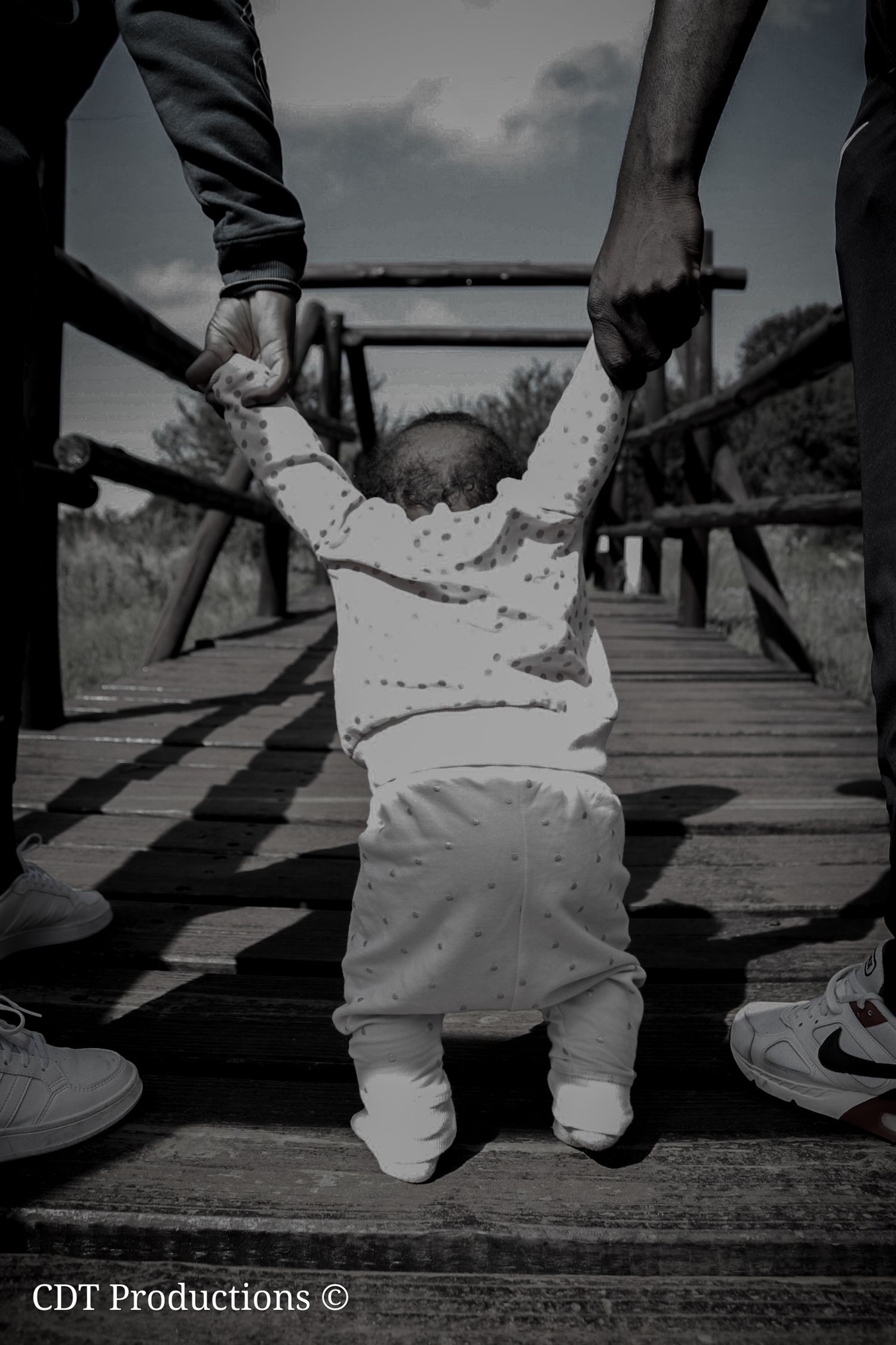 Family photography or shoot, of a family taking photos on the bridge.