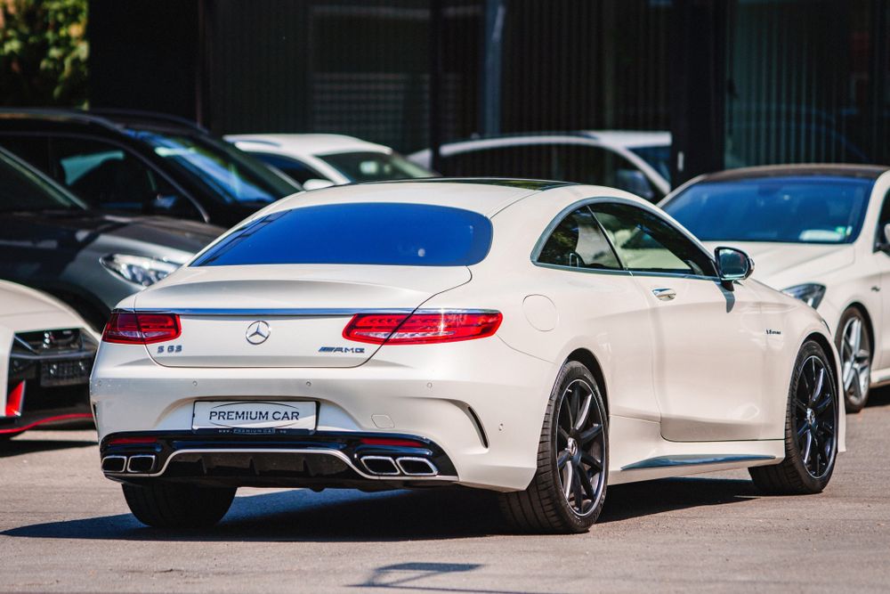 White Mercedes-Benz S-Class Coupe photographed from rear quarter angle in dealership lot.