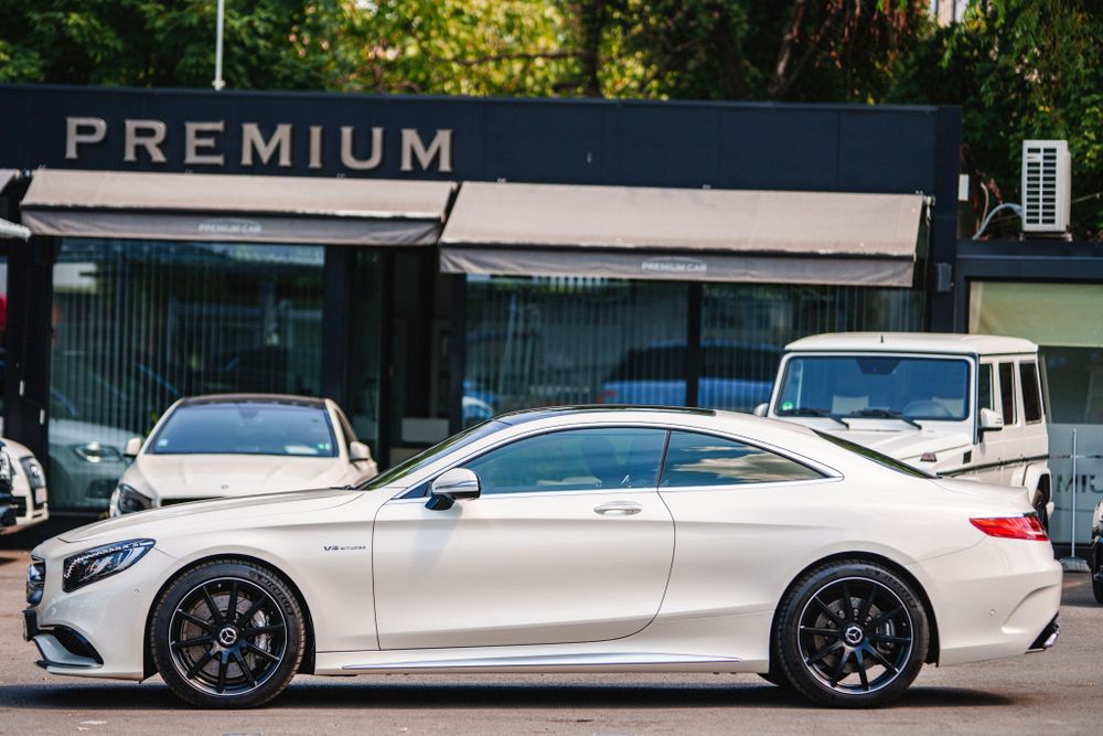 Silver Mercedes-Benz S-Class Coupe parked in front of a premium retail store.