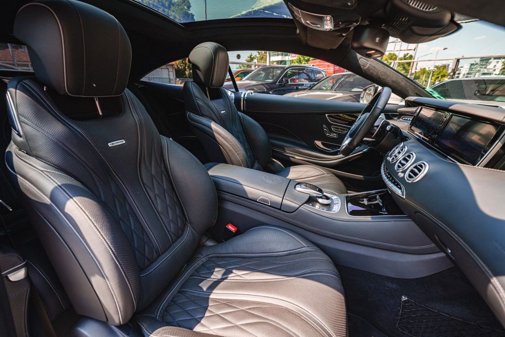 Premium quilted leather seats and dashboard of Mercedes-Benz luxury vehicle.