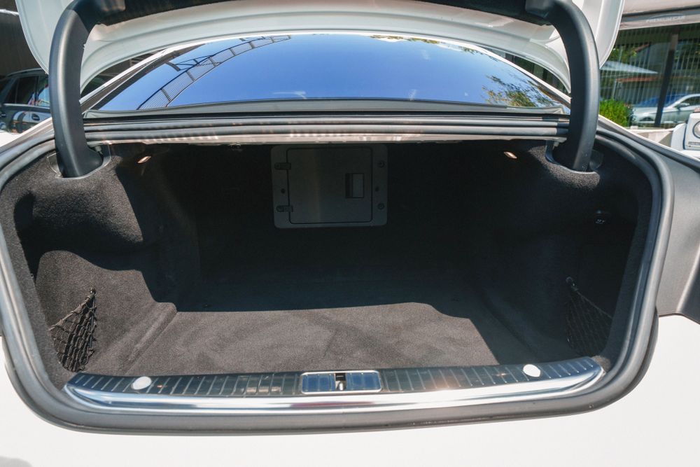 Spacious trunk interior of Mercedes-Benz luxury sedan.