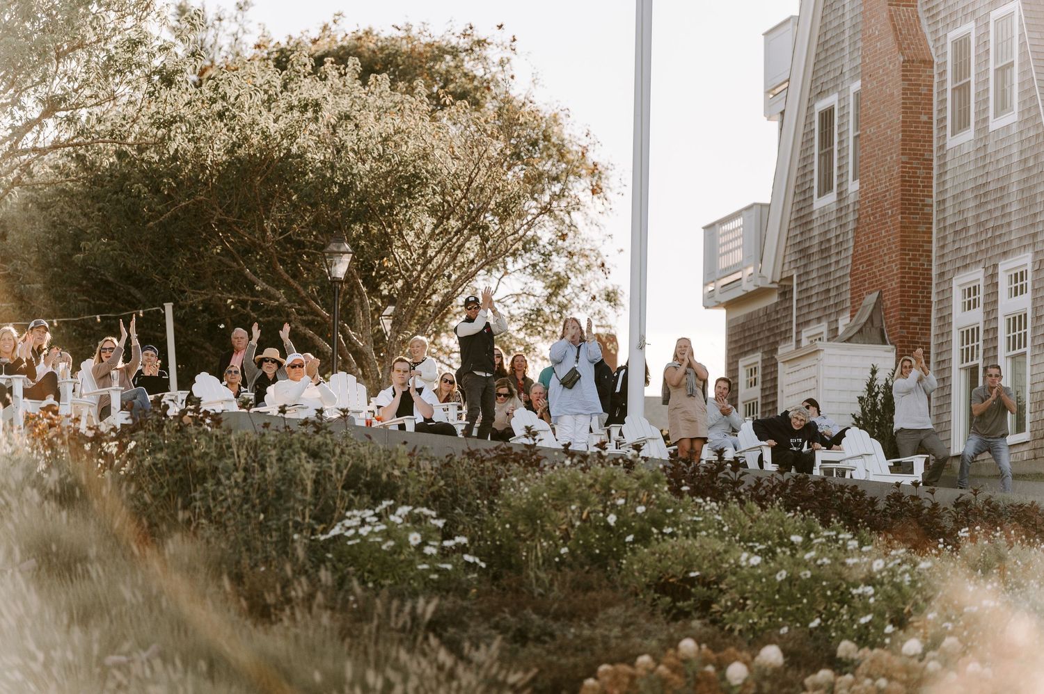 Wedding celebration takes place against a backdrop of historic buildings and trees.