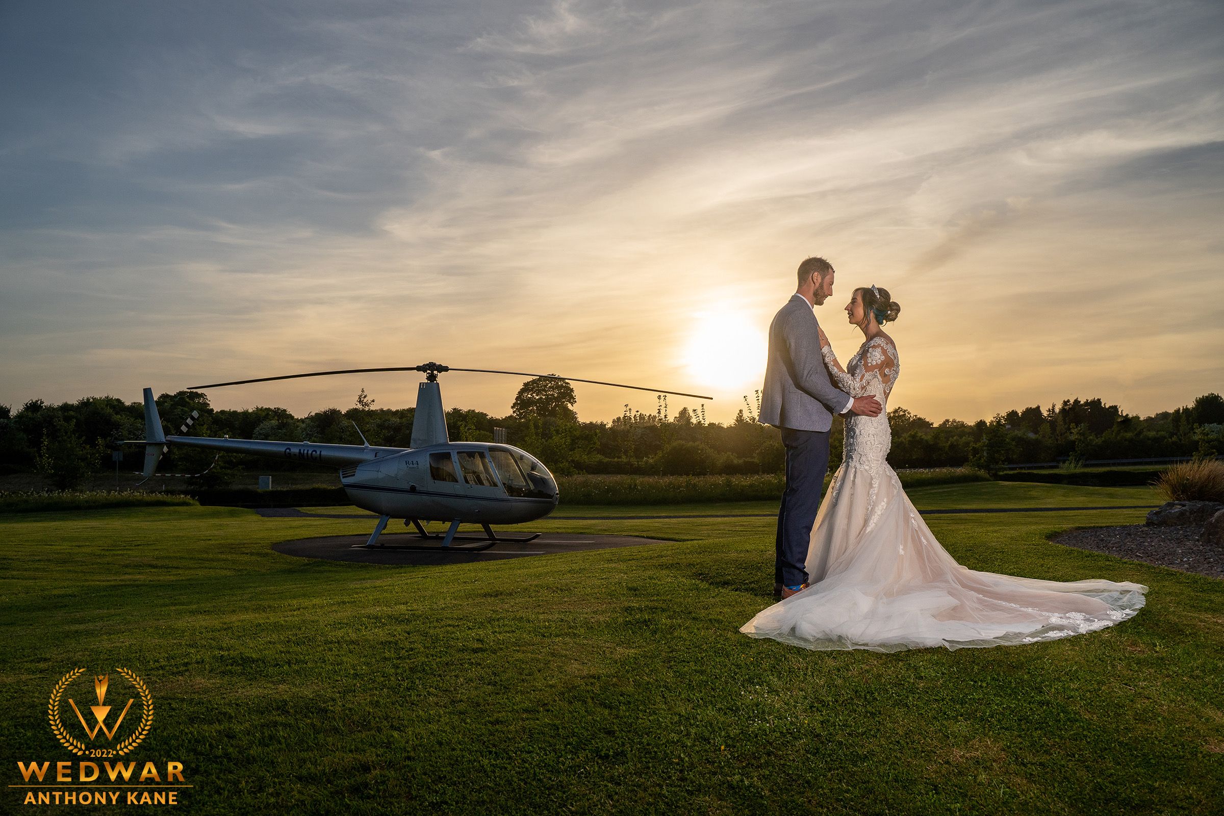 Sunset wedding portrait with helicopter on a golf course creating luxurious ambiance Co.Kerry.