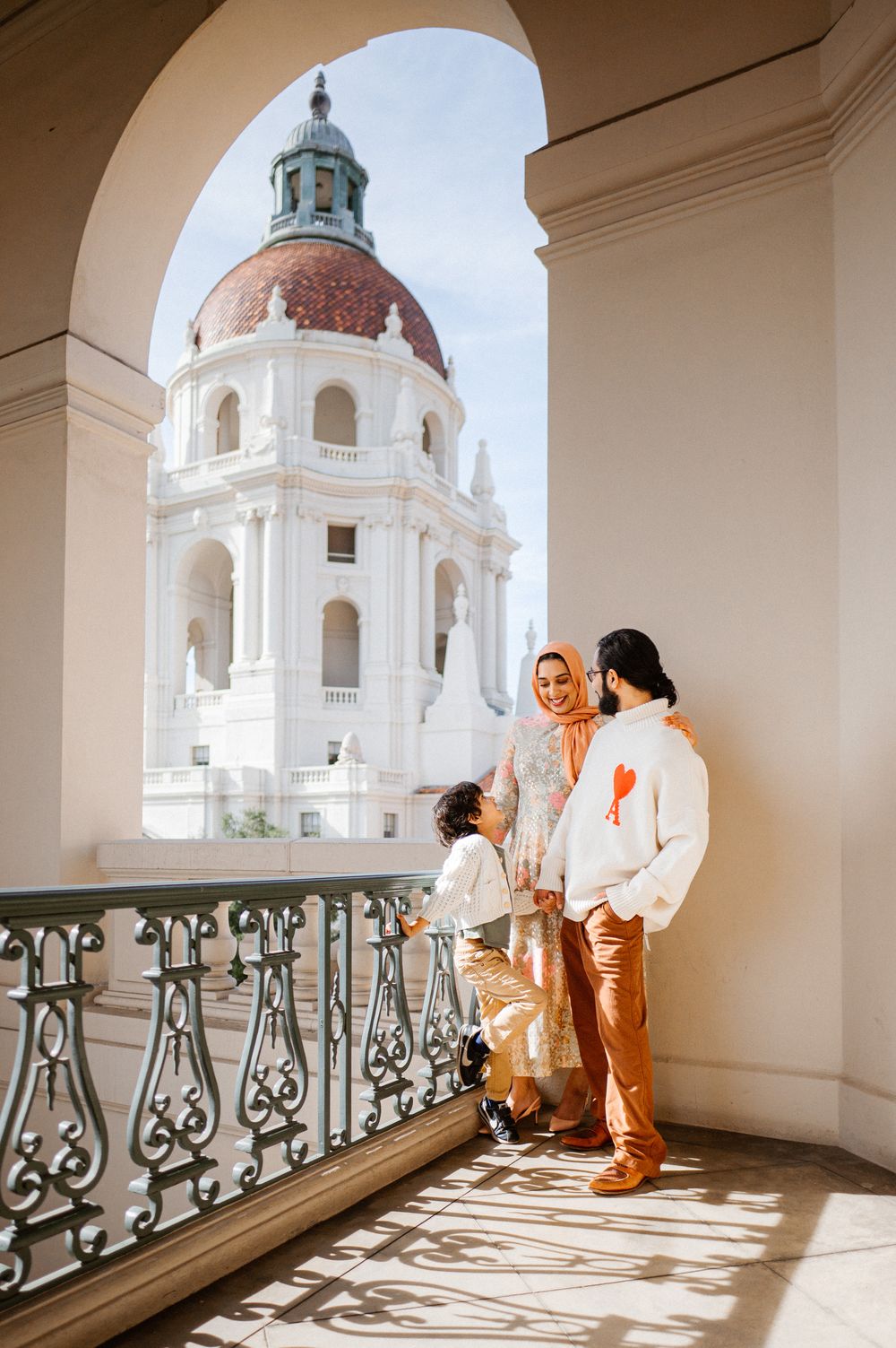 Beautiful arched colonnade with white domed architecture and ornate railings.