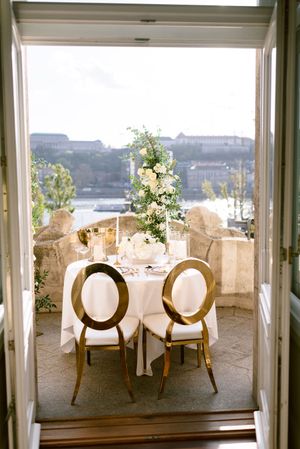 wedding-decor-with-budapest-city-view-romantic-terrace-reception-setup-floral-centerpieces-destination-hungary.jpg