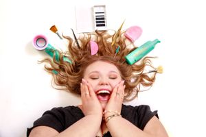 Beauty products and cosmetics tossed in air against white background with motion blur.